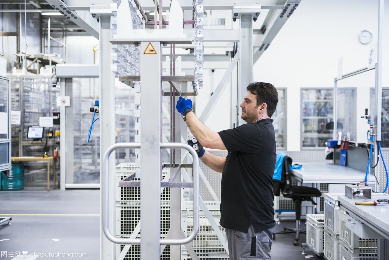 在工廠車間工作的人掛在架子上的產(chǎn)品